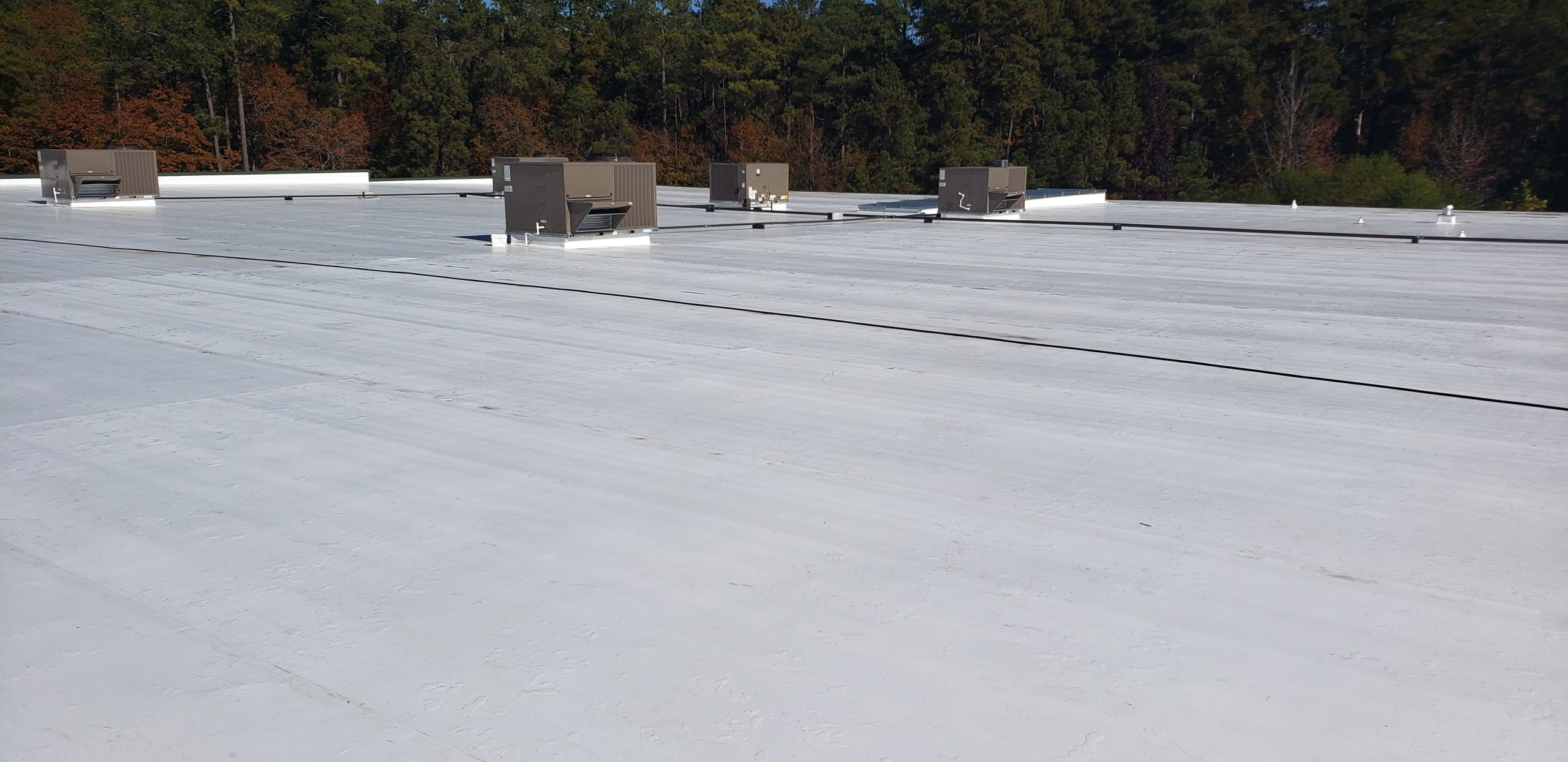 Flat commercial roof with HVAC units, designed for durability and energy efficiency, relevant to Grier Roofing's services in commercial roof installation and maintenance.