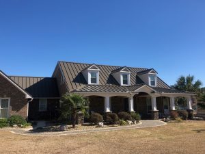 Residential home featuring a modern metal roof, showcasing architectural details and landscaping, emphasizing durability and aesthetic appeal for roofing services by Grier Roofing.
