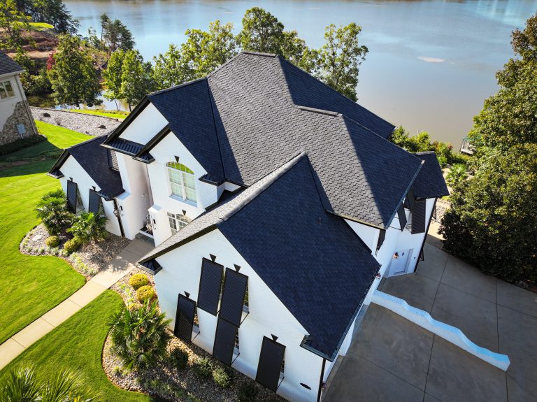Stylish residential roof with dark shingles and white exterior, showcasing quality craftsmanship and durability, relevant to Grier Roofing's focus on roofing solutions in Greenville, SC.