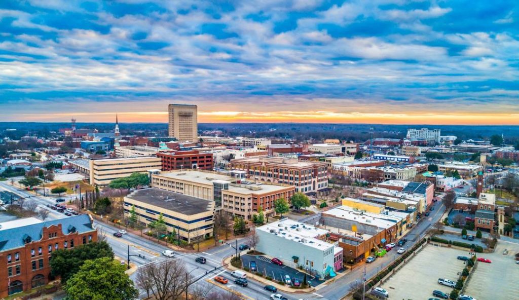 Aerial view of Spartanburg, South Carolina, showcasing downtown buildings and streets, highlighting the city's vibrant community and economic development.