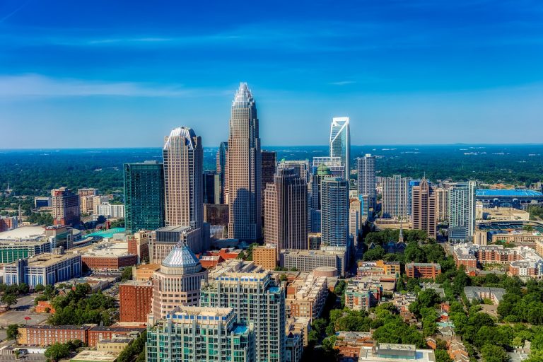 Aerial view of Charlotte, NC skyline showcasing modern skyscrapers and urban landscape, highlighting the city's status as a major financial hub and cultural hotspot.