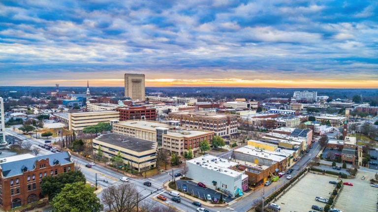 Aerial view of Spartanburg, SC, showcasing the downtown area with commercial buildings and a vibrant skyline, highlighting the city's economic growth and development.